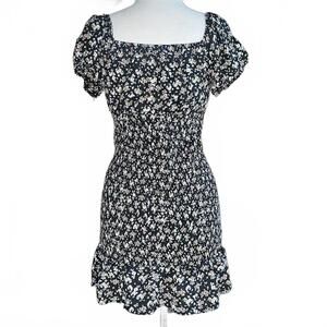 Black floral ruffle milkmaid style mini dress, puff sleeves.